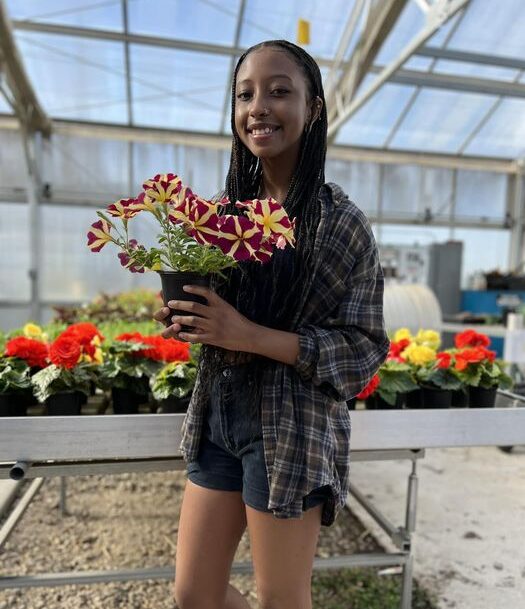 DHS Plant Sale student holding flower pot